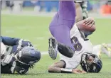  ??  ?? Baltimore QB Lamar Jackson scores a touchdown on a fourth-down keeper play and lands on his head next to Seattle’s Tre Flowers, left, in the Ravens’ 30-16 win on Sunday. Jackson threw for 143 yards and ran for another 116 yards and the one score.