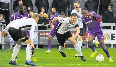  ??  ?? Maidstone’s Nana Kyei tries to get beyond Dartford captain Tom Bonner