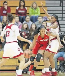  ?? HERALD-TIMES] [JEREMY HOGAN/THE ?? Ohio State’s Stephanie Mavunga, who had 20 points and 18 rebounds, works the ball against Indiana’s Kym Royster of Newark, right, and Jaelynn Penn.