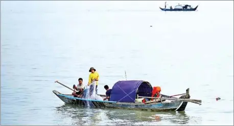  ?? HONG MENEA ?? Men fish on the Mekong River in Cambodia. The Mekong is home to some of the planet’s most unique and rare species.