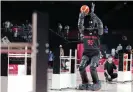  ?? Photograph: Thomas Coex/AFP/ Getty Images ?? Toyota has created a 6ft10in basketball­shooting robot named CUE that uses sensors on its torso to judge the distance and angle of the basket.