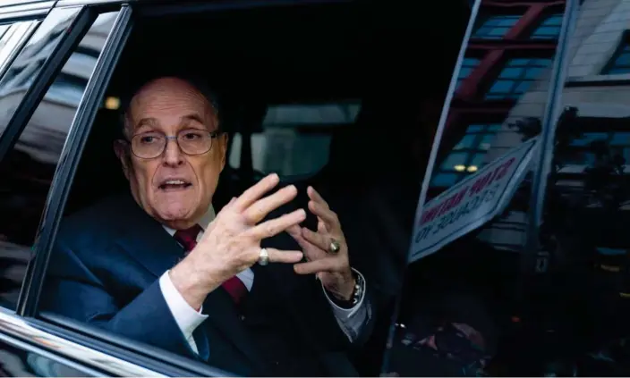  ?? Photograph: José Luis Magaña/AP ?? Rudy Giuliani talks to reporters as he leaves after his defamation trial in Washington on Friday. He has vowed to appeal the verdict.