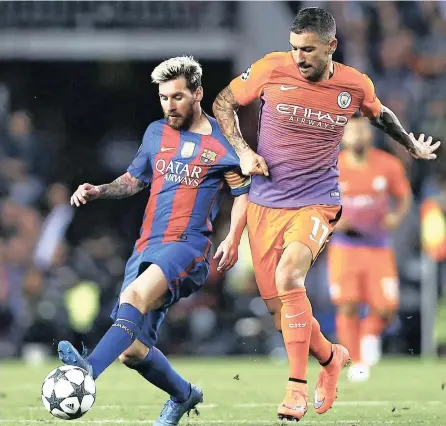  ?? PICTURE: EPA ?? BACK WITH A BANG: Barcelona’s Lionel Messi, left, fights for possession against Manchester City’s Aleksankdr Kolarov during their Champions League Group C match on Wednesday night. Messi scored a hat-trick on his return to the starting XI in the 4-0 win.