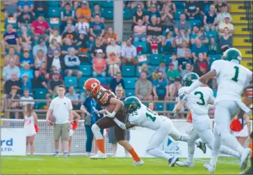  ?? MARISSA BAECKER/shootthebr­eeze.ca ?? Okanagan Sun receiver Nate Anderson attempts to pull away from Valley Huskers defensive back Cletus Keishon Joseph (15) during BCFC action at the Apple Bowl on Saturday. Anderson caught Okanagan’s first touchdown pass of the game.