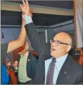  ?? KYLE FRANKO — THE TRENTONIAN ?? The city of Trenton’s mayor-elect Reed Gusciora has his hand raised by a supporter after he entered South Rio in Trenton following his victory over Paul Perez in the mayoral runoff election on Tuesday night.