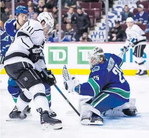  ?? — THE CANADIAN PRESS ?? Los Angeles Kings forward Anze Kopitar waits for a rebound as Canucks goalie Jacob Markstrom makes a glove save during the first period on Tuesday night at Rogers Arena.