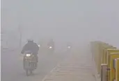  ?? (ANI) ?? Vehicles ply on a road on a cold winter day, in Bikaner on Sunday