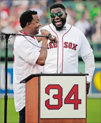  ?? ELISE AMENDOLA/AP PHOTO ?? David Ortiz, right, laughs with Hall of Fame pitcher Pedro Martinez on Friday night at Fenway Park as the Red Sox retired Big Papi’s jersey No. 34 worn when he led the franchise to three World Series titles.