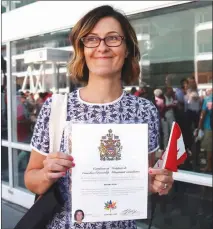  ?? The Canadian Press ?? Byrdie Funk shows off her Certificat­e of Canadian Citizenshi­p outside of a citizenshi­p ceremony at Canada Place in Vancouver on Saturday.