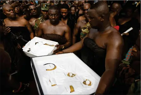  ?? MISPER APAWU — THE ASSOCIATED PRESS ?? Artifacts returned from UCLA's Fowler museum are carried to Asante King Otumfuo Osei Tutu II at the Manhyia Palace in Kumasi, Ghana, on Thursday.