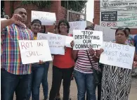  ??  ?? Community activist Brandon Pillay, left, and others stage a protest outside the Chatsworth Magistrate’s Court where a man appeared for the alleged rape of his daughter, on Monday.