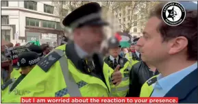  ?? ?? Marching orders: The policeman speaks to Gideon Falter at the rally