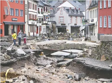  ?? INA FASSBENDER / AFP VIA GETTY IMAGES ?? The pedestrian area of Bad Muensterei­fel, western Germany, is pictured after floodwater­s tore through the area amid heavy rain. More than 120 people have died in Europe due to the flooding, most of them in western Germany.