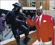  ?? DAVID KOHL - AP FILE ?? Hall of Fame second baseman Joe Morgan poses with his statue at Cincinnati’s Great American Ball Park in 2013. A family spokesman says Morgan died at his home on Sunday.