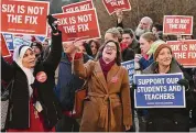  ?? Tyler Sizemore/Hearst Connecticu­t Media ?? Teachers and school faculty hold signs at the “Six Is Not the Fix” walk-in at Westhill High School in Stamford on Dec. 19.