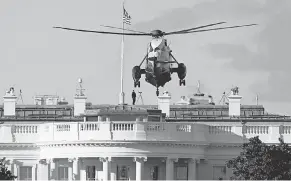  ?? WIN MCNAMEE/ GETTY IMAGES ?? Marine One over the White House in October.