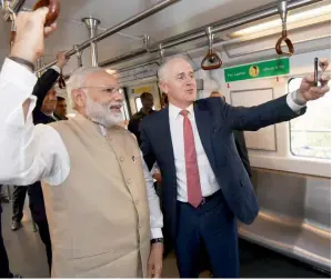  ?? PTI ?? Malcolm Turnbull takes selfie with Narerndra Modi in a Metro train in New Delhi on Monday. —