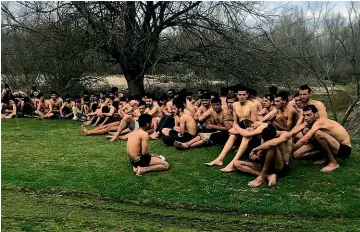  ?? AP ?? This photo provided by Turkey’s IHA news agency purports to show a group of about 100 migrants in Edirne, Turkey, near the border with Greece, who were allegedly sent back by Greek security forces after being stripped of their clothes.