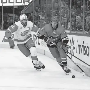  ?? JAMES GUILLORY/USA TODAY SPORTS ?? Hurricanes left wing Jake Guentzel skates with the puck past Red Wings defenseman Jeff Petry during the first period in Raleigh, N.C., on Thursday.