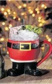  ?? Steve Gonzales / Staff photograph­er ?? The tropical Yippie Ki Yay drink is served in a Santa mug with a splash of irony.