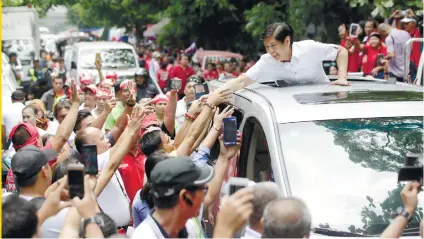  ?? AP FOTO ?? RECOUNT: Former senator Bongbong Marcos Jr. shakes hands with supporters at the start of manual counting of votes for the vice presidenti­al polls.