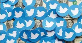  ?? REUTERSPIC ?? Twitter logos and US dollar banknotes are seen in this illustrati­on. Musk has cut half the staff at Twitter and has vowed to start charging users more. –