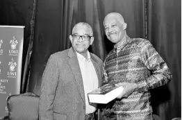  ?? ?? Ian Randle (left), founder/chairman, Ian Randle Publishers, with Professor Sir Hilary Beckles, Vice Chancellor of The University of the West Indies (UWI), following the presentati­on of a copy of ‘Interrogat­ing Justices’ to him at the Festschrif­t in honour of Sir Hilary at The UWI, Mona, on Thursday, February 15.