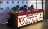  ?? JOHN BREWER - ONEIDA DAILY DISPATCH ?? From left, Davey Moffett, Olivia Evans, and Andrew Roden sign their national letters of intent on Wednesday, Nov. 8.