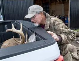  ?? ?? Ron Feits, of New Brighton, looks over a recently harvested deer Sunday at Doug Peffer's Deer Cutting, Smokehouse & Big Game Processing in Ellwood City.
