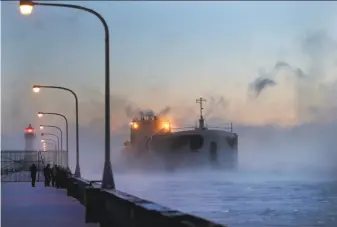  ?? David Joles / Minneapoli­s Star Tribune ?? Steam rises from Lake Superior as a freighter comes into harbor Sunday in Duluth, Minn. The wind chill dipped to 36 below zero in the city known for its brutally cold winters.