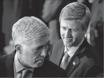  ?? AP FILE PHOTO ?? In a Dec. 3 photo, Nick Ayers, right, listens as Supreme Court Associate Justice Neil Gorsuch waits for the arrival of the casket for former President George H.W. Bush to lie in State at the Capitol on Capitol Hill in Washington.