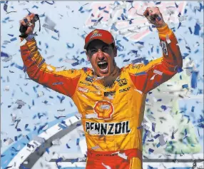  ?? Brynn Anderson ?? The Associated Press Joey Logano celebrates ending a nearly yearlong victory drought on Sunday after capturing the NASCAR Cup Geico 500 at Talladega Superspeed­way in Talladega, Ala.