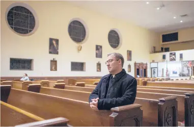  ?? MARK MIRKO/HARTFORD COURANT ?? Father Michael Casey prays during a service inside St. Francis of Assisi Church in New Britain where the archdioces­e will be closing several churches and consolidat­ing operations in two others.