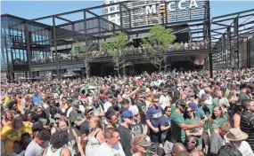  ??  ?? A huge crowd fills the Fiserv Forum plaza to see Giannis Antetokoun­mpo.
