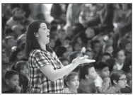  ?? NWA Democrat-Gazette/FLIP PUTTHOFF ?? Pamela Pittman, Westside music teacher, directs students Friday during a patriotic song performanc­e.