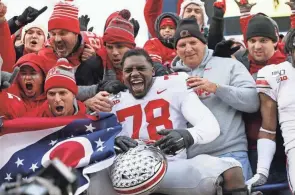  ?? ADAM CAIRNS/COLUMBUS DISPATCH ?? Ohio State tackle Nicholas Petit-frere, here celebratin­g with fans after a win over Michigan in 2019, will serve as a public spokesman for a Tampa technology startup.