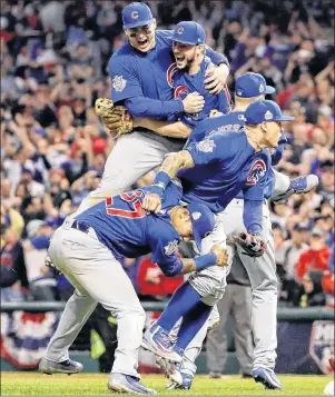  ?? AP PHOTO ?? In this November 2016 file photo, the Chicago Cubs celebrate after defeating the Cleveland Indians 8-7 in 10 innings in Game 7 of Major League Baseball’s World Series in Cleveland.