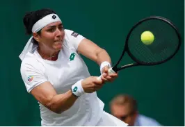  ?? (Reuters) ?? TUNISIA’S ONS JABEUR made Wimbledon history with a stunning 5-7, 6-1, 6-1 comeback win over Poland’s Iga Swiatek yesterday to become the first Arab woman to reach the quarterfin­als of the grass-court Grand Slam.