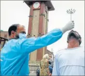  ?? ANI ?? A paramedic taking swab sample of a man to conduct a rapid antigen test for Covid-19 in Srinagar on Saturday.