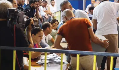  ??  ?? The counting of votes as the process was getting started last night at the Granaries Photo: Michael Camilleri