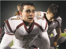  ?? Scott Strazzante / The Chronicle ?? Beau Barrington (7) and other Cardinal Newman-Santa Rosa football players were emotional after the Cardinals’ 59-56 loss to Marin Catholic in the Division 3 title game in Rohnert Park.