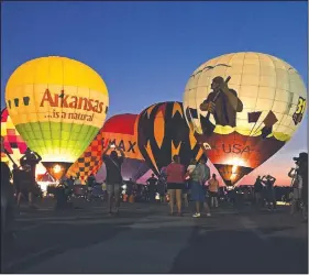  ?? Arkansas Democrat-Gazette/BILL BOWDEN ?? The annual Arkansas Hot Air Balloon State Championsh­ip kicked off Friday night with a balloon glow at the Boone County Regional Airport in Harrison. The event, which includes 11 teams of balloonist­s, continues through Sunday morning.