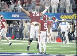  ?? MICHAEL AINSWORTH — THE ASSOCIATED PRESS ?? Quarterbac­k Bryce Young (9) of No. 1-ranked Alabama celebrates with offensive lineman Chris Owens after throwing a touchdown pass against No. 4 Cincinnati at the Cotton Bowl.