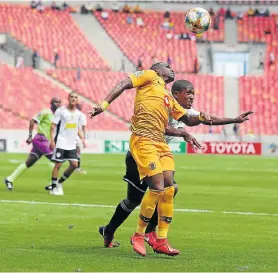  ?? Picture: RICHARD HUGGARD/GALLO IMAGES ?? HEAD GAMES: Mogamat May of The Magic FC and George Maluleka of Kaizer Chiefs fight for the ball during their Nedbank Cup last-16 match at the Nelson Mandela Bay Stadium