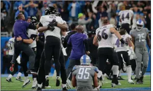  ?? (AP/Tony Ding) ?? Members of the Baltimore Ravens celebrate Justin Tucker’s NFL-record 66-yard field goal on Sunday as Detroit’s Romeo Okwara sits dejectedly after the Lions’ 19-17 loss. More photos at arkansason­line.com/927nflweek­3/