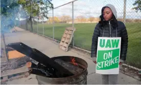  ?? Photograph: Rebecca Cook/Reuters ?? Striking United Auto Workers member Anesha Towell keeps warm at a burn barrel while picketing at the General Motors Detroit-Hamtramck Assembly in Detroit, Michigan, on Thursday.