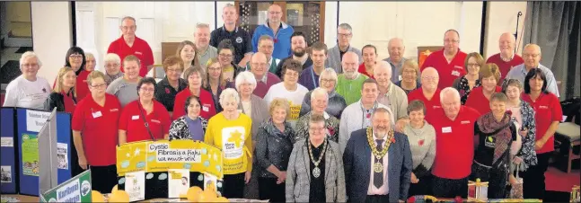  ??  ?? The mayor of Hinckley and Bosworth, Councillor Ozzy O’Shea, and his consort, wife Jenny, front centre, with representa­tives of charities and good causes offering gifts to needy people across the borough and around the world through Hinckley...