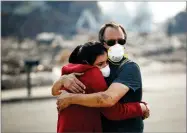  ?? AP PHOTO BY JAE C. HONG ?? Howard Lasker, right, comforts his daughter, Gabrielle, who is visiting their home for the first time since a wildfire swept through it Sunday in Santa Rosa.