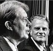  ?? AJC 1972 ?? Gov. Jimmy Carter (left) talks with Dr. Billy Graham at prayer breakfast in 1972.