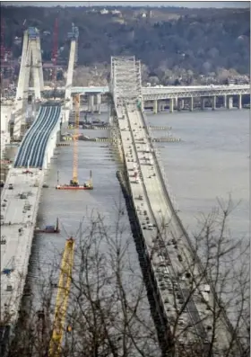  ?? AP FILE PHOTO ?? Traffic uses the old Tappan Zee Bridge, right, during constructi­on of its replacemen­t, the Gov. Mario M. Cuomo Bridge in January.